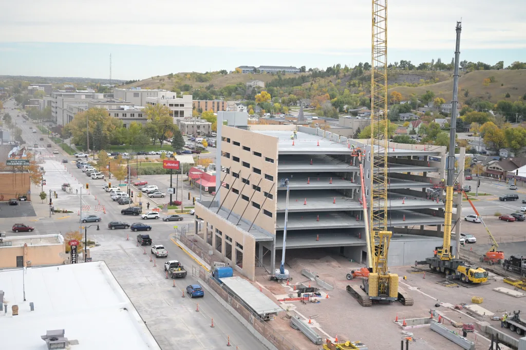 Construction cranes in downtown Rapid City work on multi-level Block 5 project under construction.