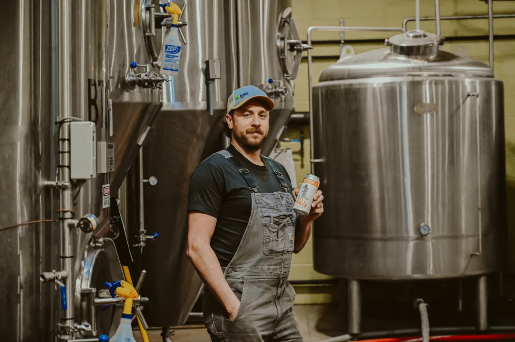 Head Brewer Mike Beebe in front of Firehouse Brewing Company fermentation vessel