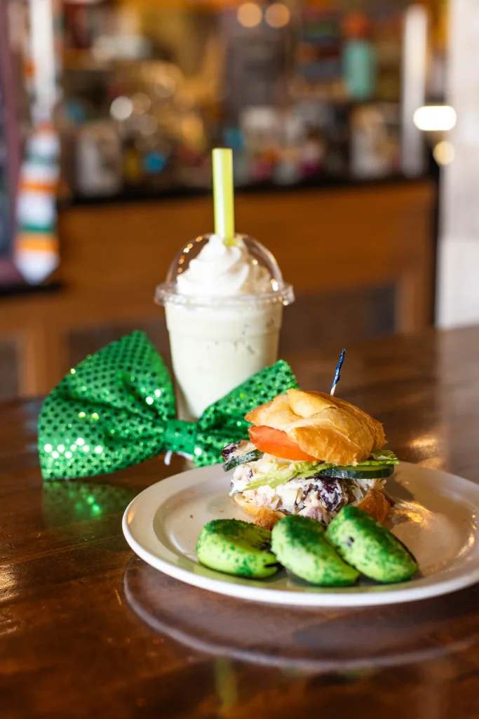 Mint dipped oreos, sandwich and blended alternative fuel drink with green bow tie on a table