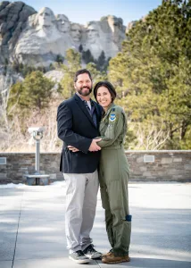 Monika Johncour and husband in front of mount rushmore