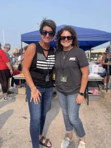 Tif Taylor-Robertson and Lynn Kendall volunteer at military appreciation bbq