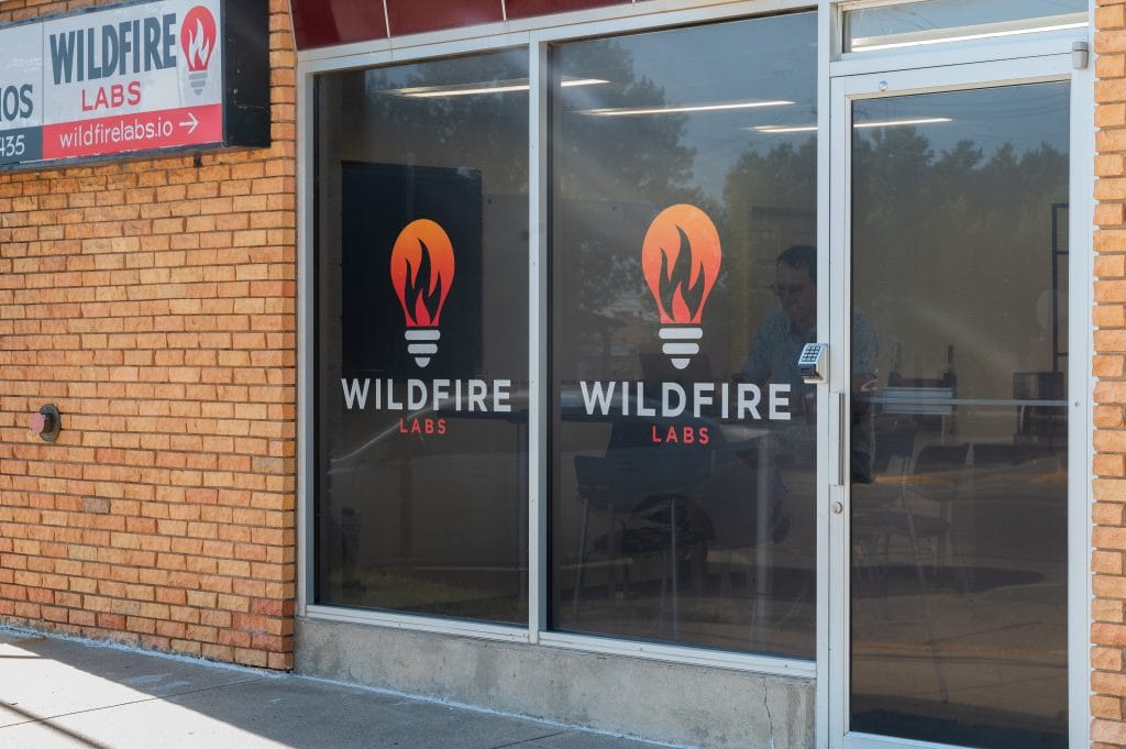 Exterior photo of Wildfire Labs in downtown Rapid City. Windows with wildfire logo