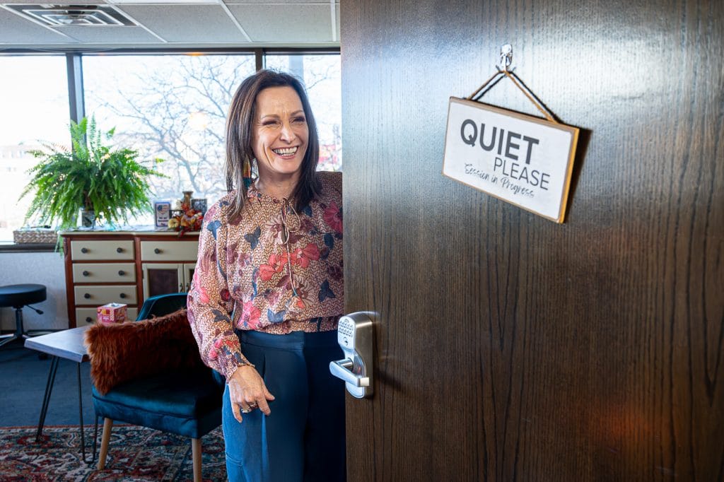 Stacey Keyser opens a door at her Rapid City Counselor office with sign that reads quiet please.