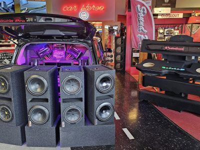 Sound Pro store display with 10" subwoofer speakers in front of a vehicle with trunk open