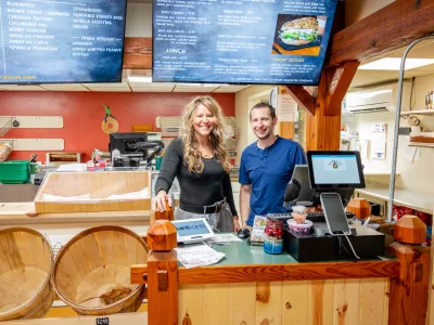 Marla Eric Hawronsky Black Hills Bagels owners behind cash register of bagel shop