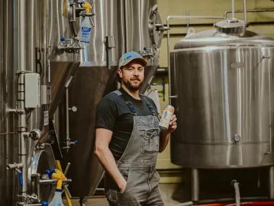 Head Brewer Mike Beebe in front of Firehouse Brewing Company fermentation vessel