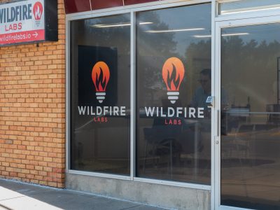 Exterior photo of Wildfire Labs in downtown Rapid City. Windows with wildfire logo