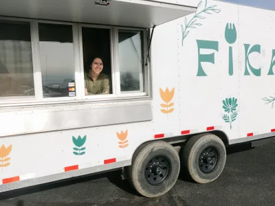 Jess Tolman-Stickney inside white FIKA Food truck